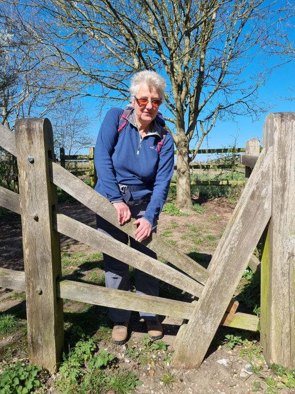 Person crossing via the clapper gate stile